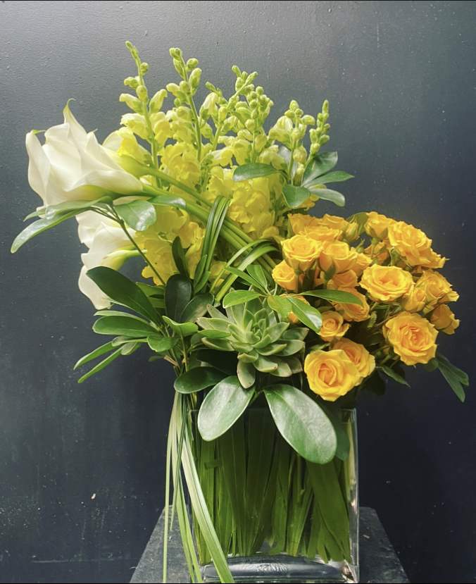 Mini calla lilies, snap dragons, garden spray roses, succulent, lily grasses, greenery