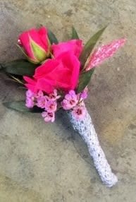 Select this bright boutonniere consisting of barbie pink roses and pink filler