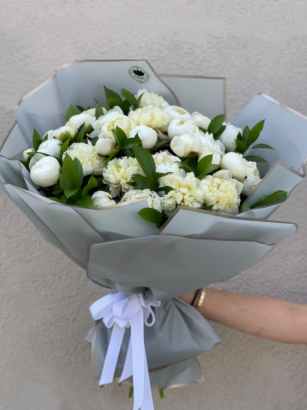 Step into elegance with this bouquet featuring 30 white Peonies, wrapped in