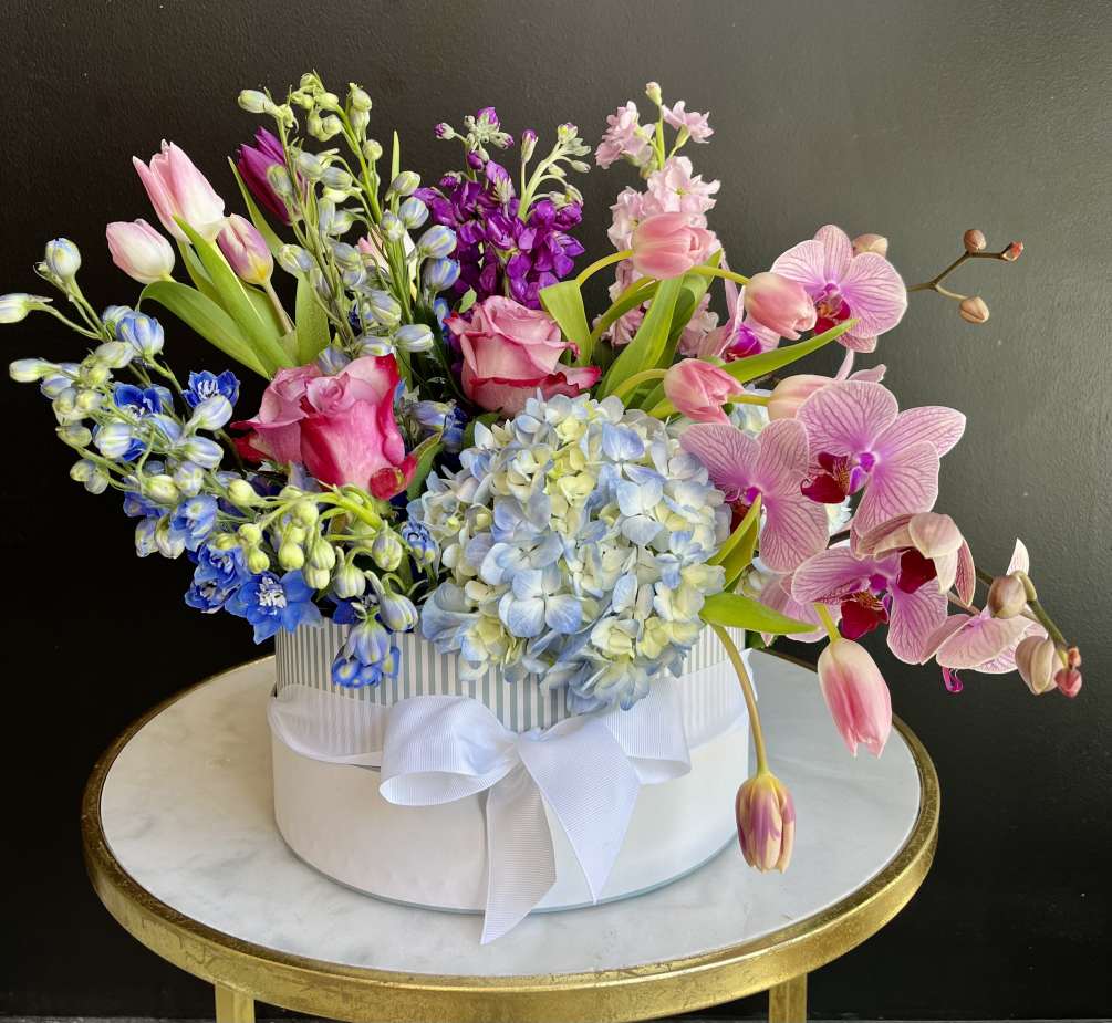 Celebrate Mom with this luxury hat box filled with pretty Tulips, Hydrangeas