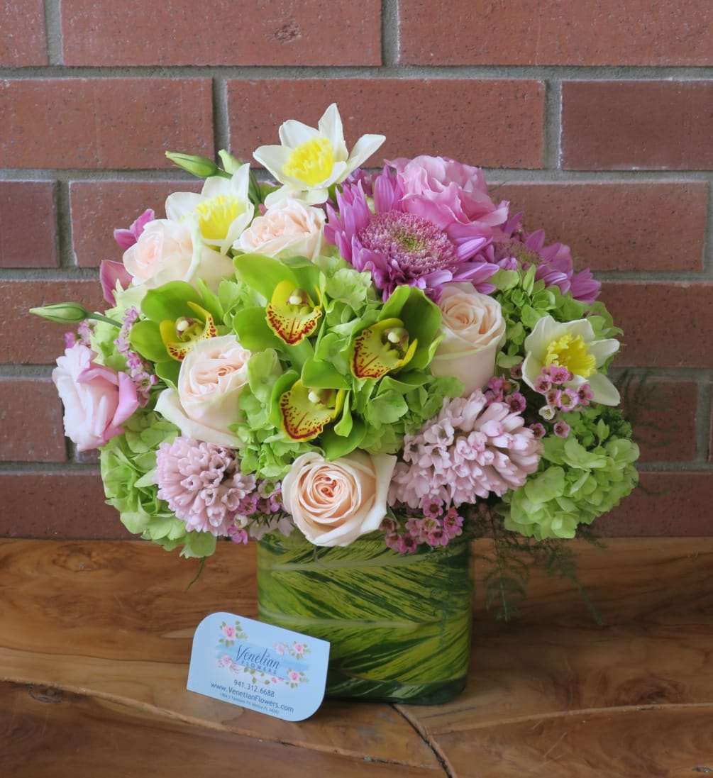 This bouquet of green orchids, fragrant hyacinths, hydrangeas, daffodils, mums and roses