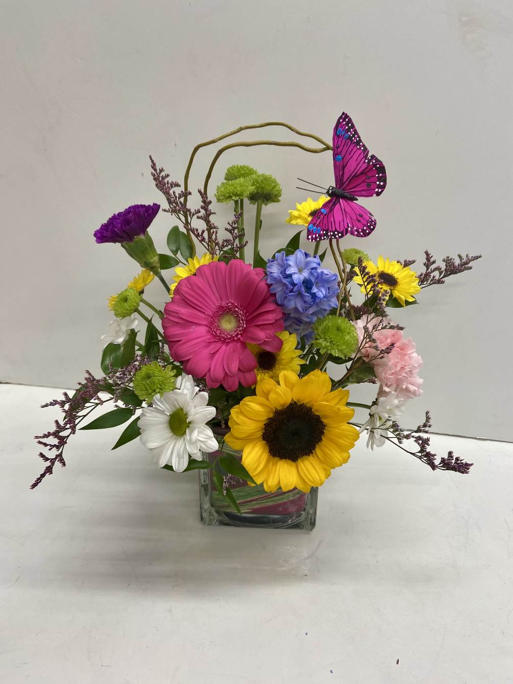 Hippy Psychedelic confetti colors with gerbera daisies, sunflowers, roses. carnations, green buttons