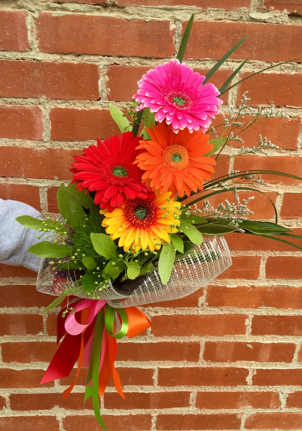 Bright summer colors of Gerbera Daisies in a wrapped bouquet. can be