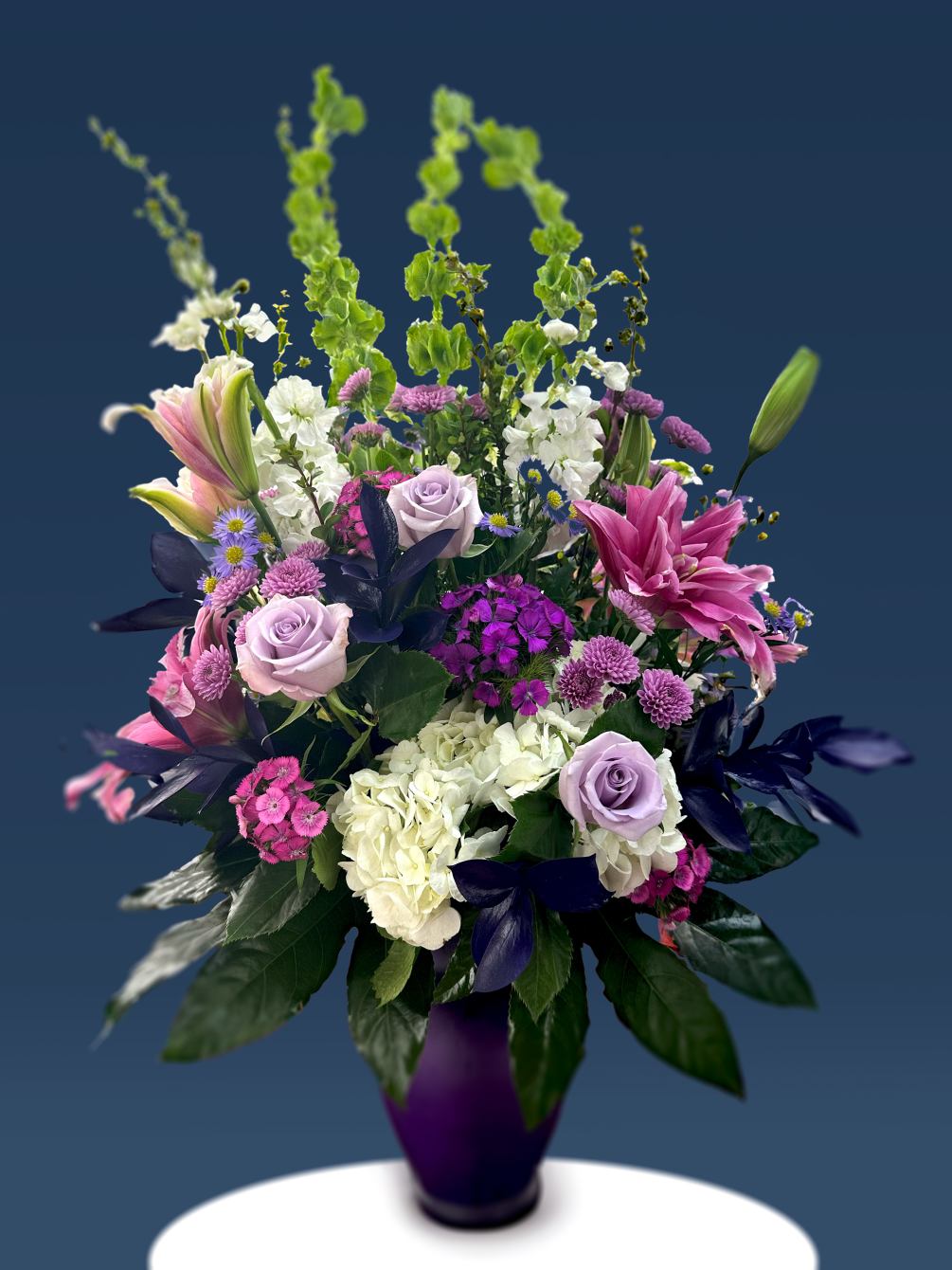 Rich and elegant. A collection of purple and hot pink flowers composed