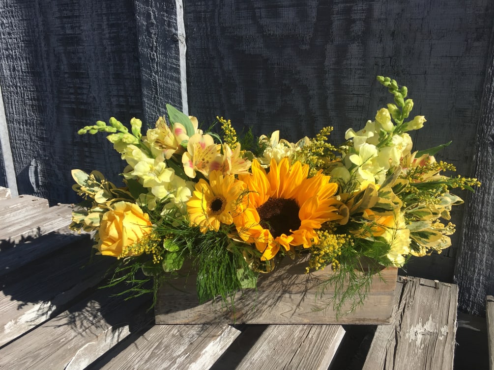 A bright and full beautiful array of yellow and orange flowers in