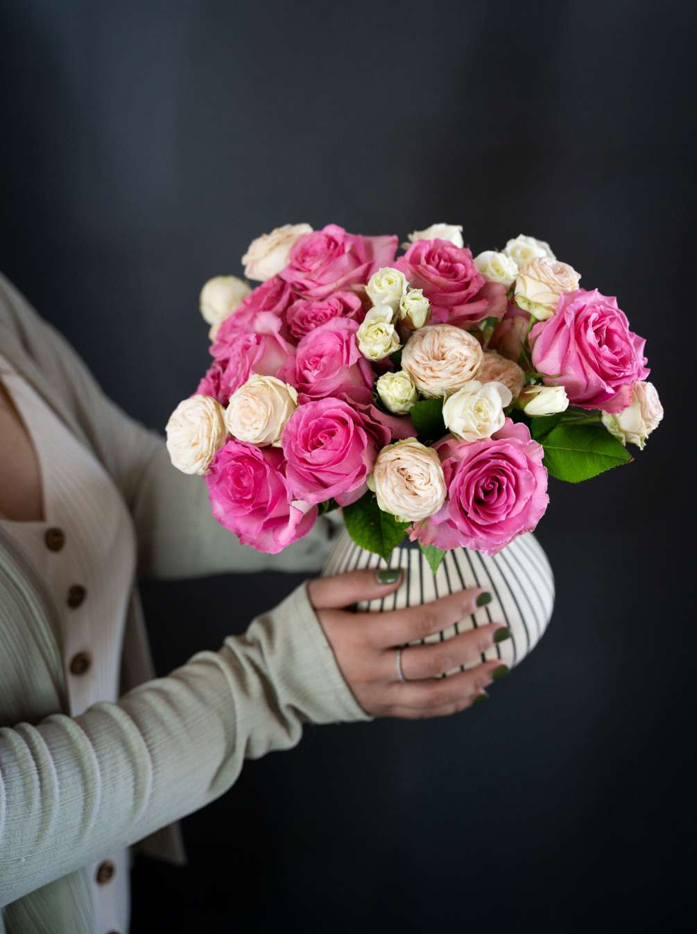 Soft pink roses and garden spray roses erupt out of a stunning