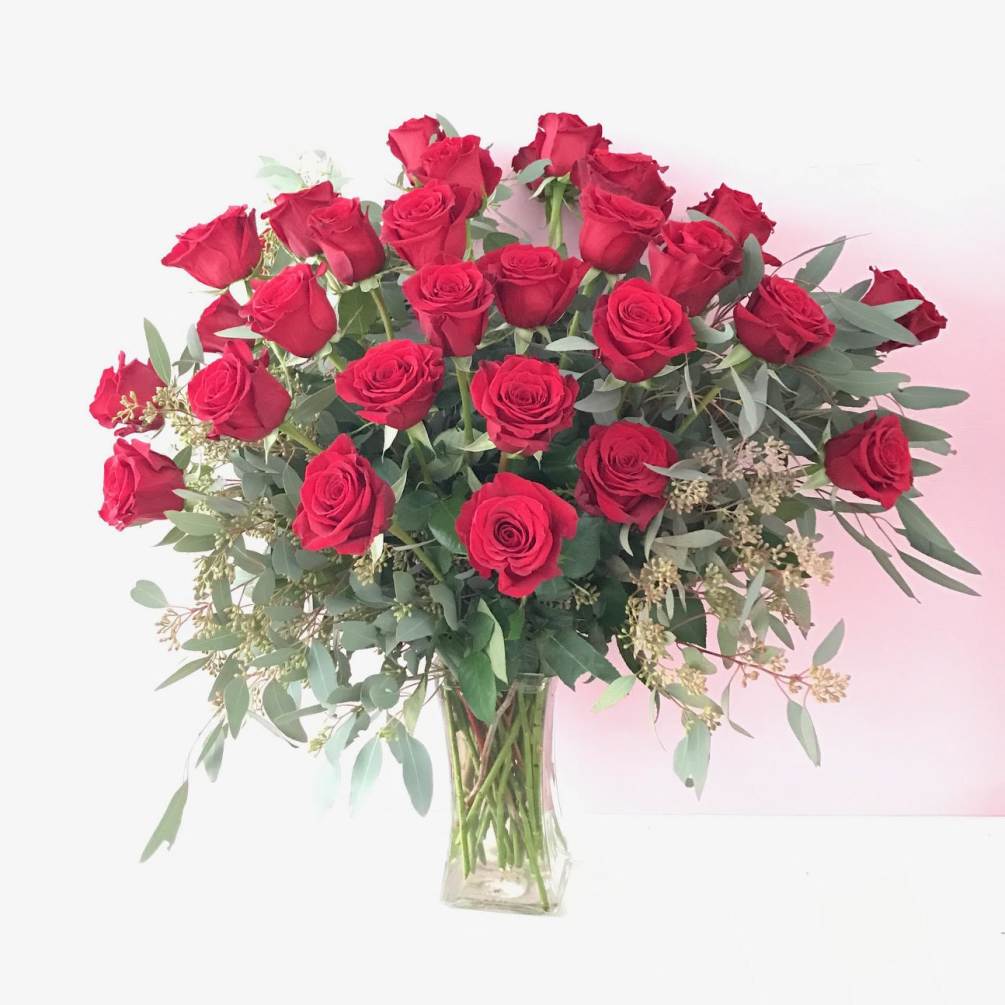 36 premium Long stemmed red roses with luscious greenery and a premium
