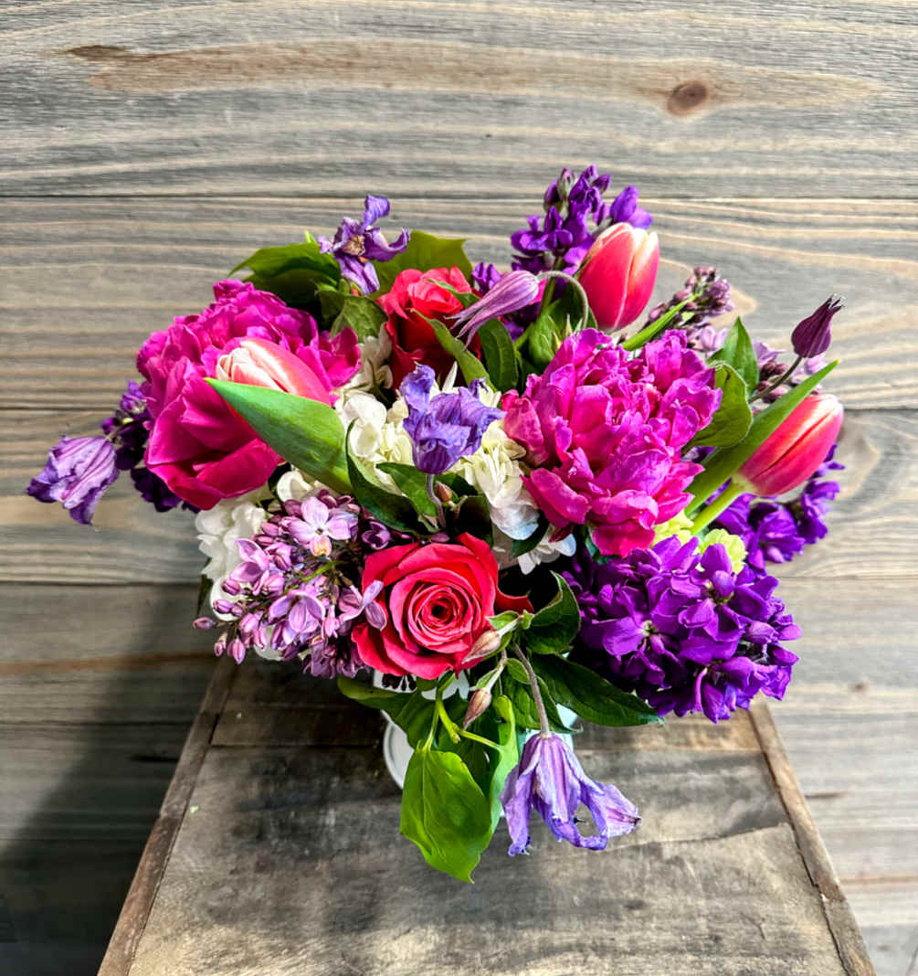 A mix of magenta, plum and violet toned blooms arranged artfully in