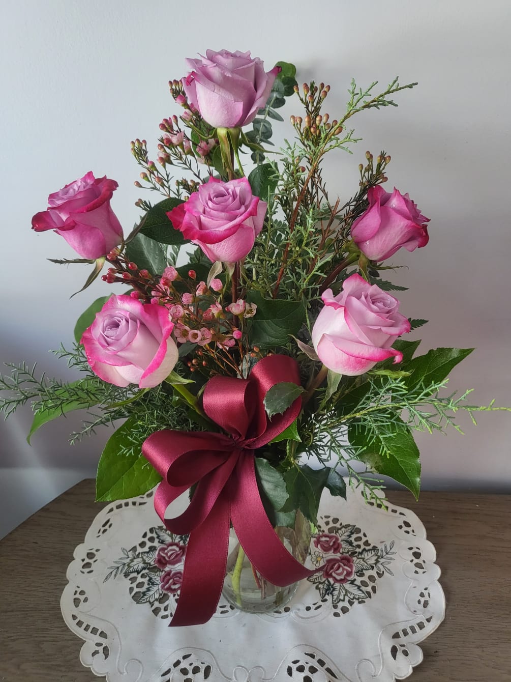 Designed with 6 toses a bow and waxflower