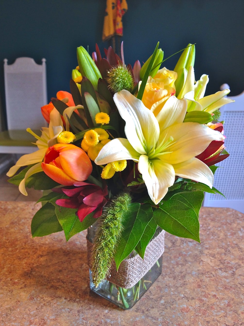 A low rectangular vase holds this monochromatic mix of blooms...yellows, creams, oranges