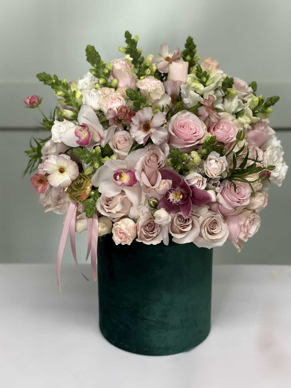 A rich collection of roses, spray roses, Orchids, Snapdragons, Butterfly Ranunculus, and