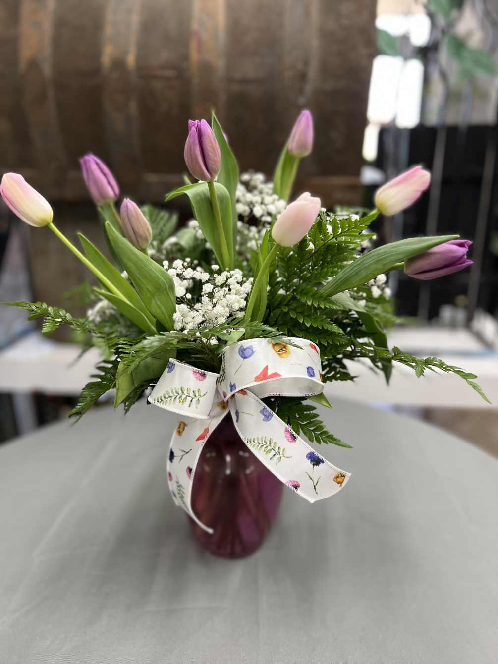 Beautiful tulips with greenery and filler in a beautiful  vase or