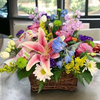 Filled with a lovely variety of spring flowers  this gracious basket