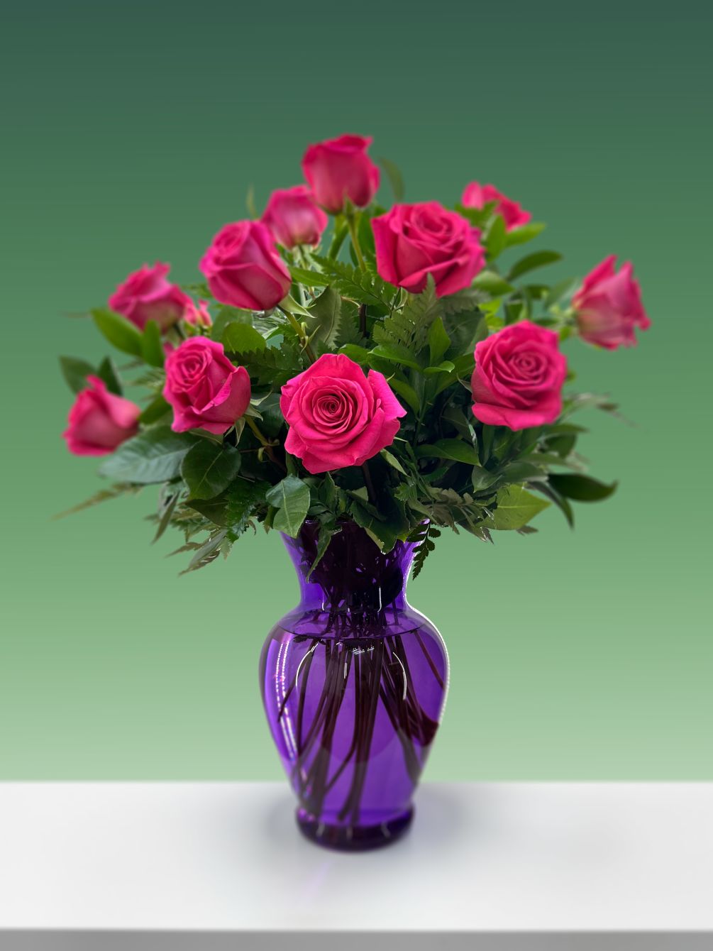 Surprise someone with these Hot Pink Roses arranged in a vase.