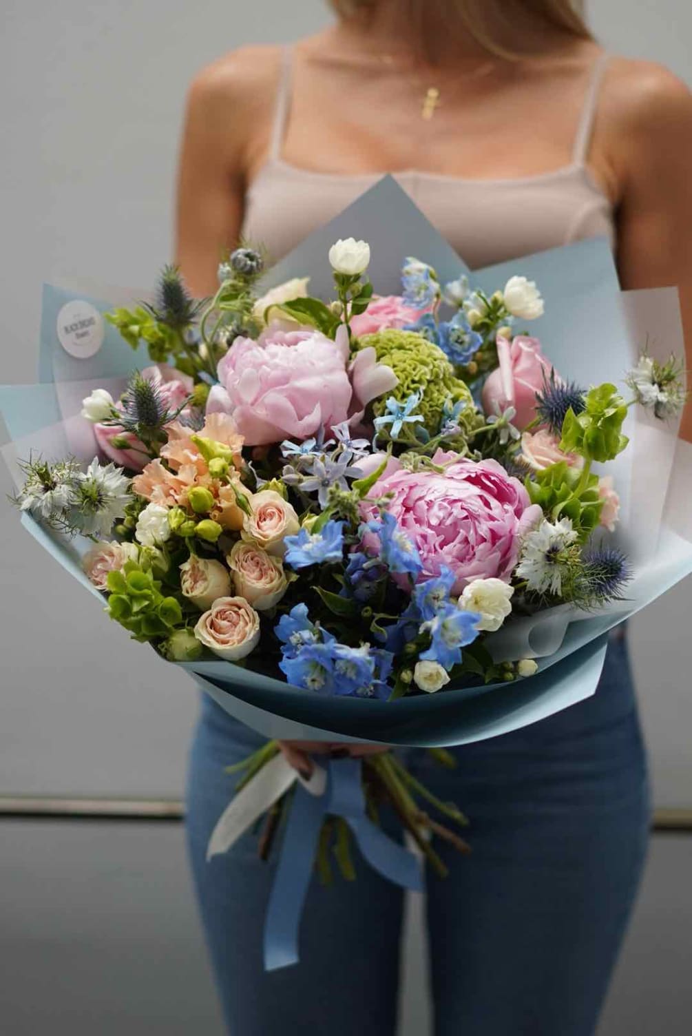 Blush peonies, pink garden roses, spray roses, blue tweedia, blue delphinium, blue