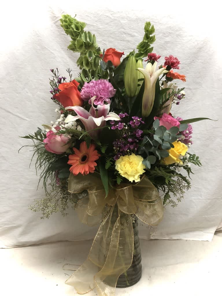Stargazer lillies, roses, carnations daisies and wax flower.  Simple, fresh and