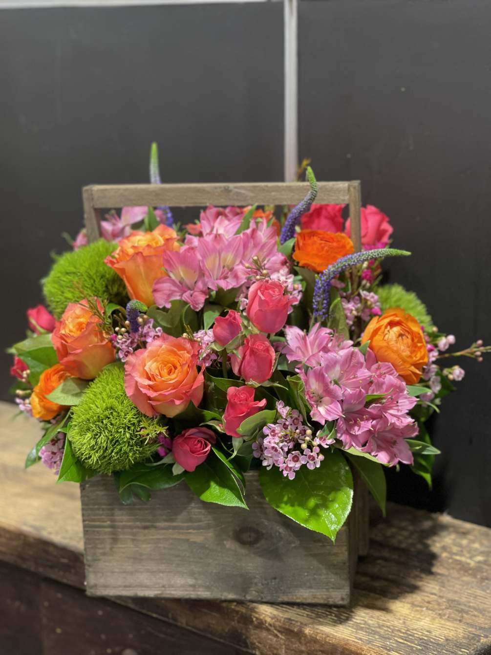Cheerful combination of Roses, Dianthus, Spray Roses, Anemone,Veronica and other seasonal flowers