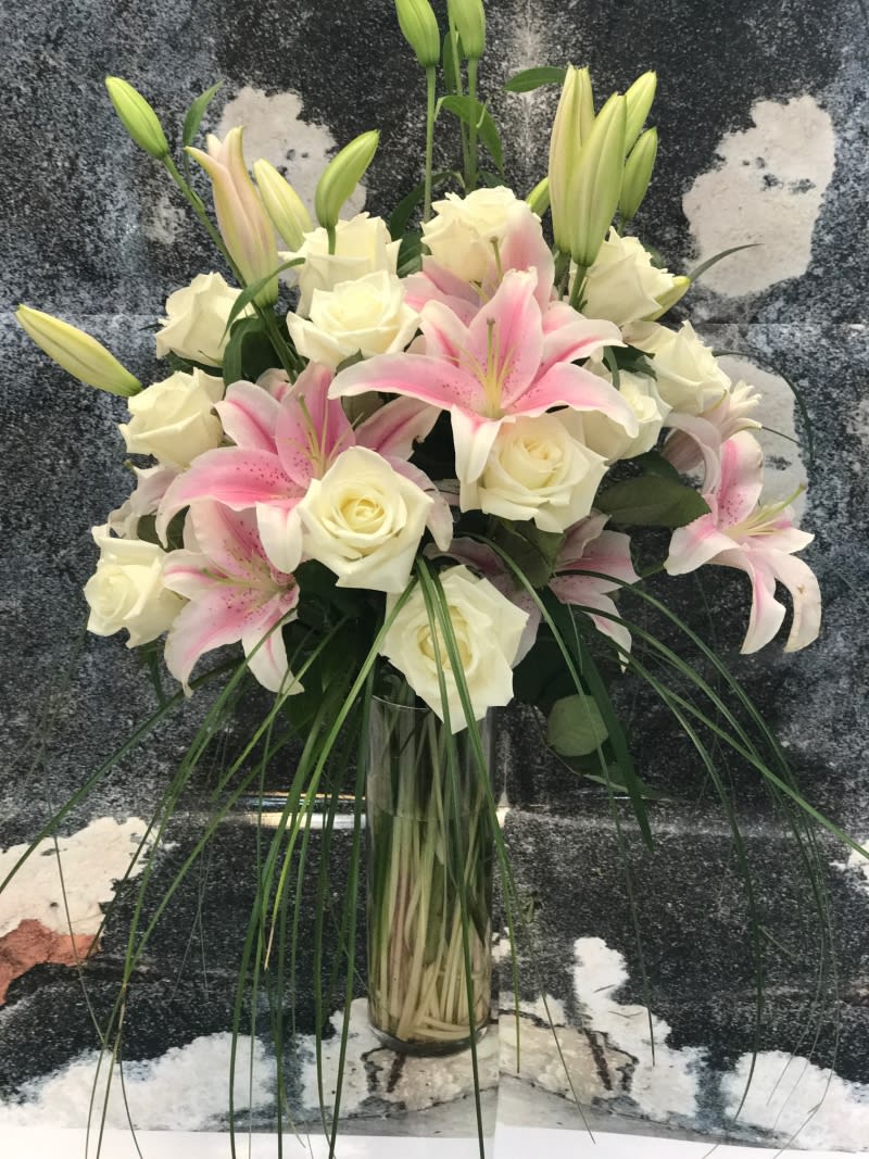 Simple and Tall design arranged with Pink Lilies, one dozen White Roseswith
