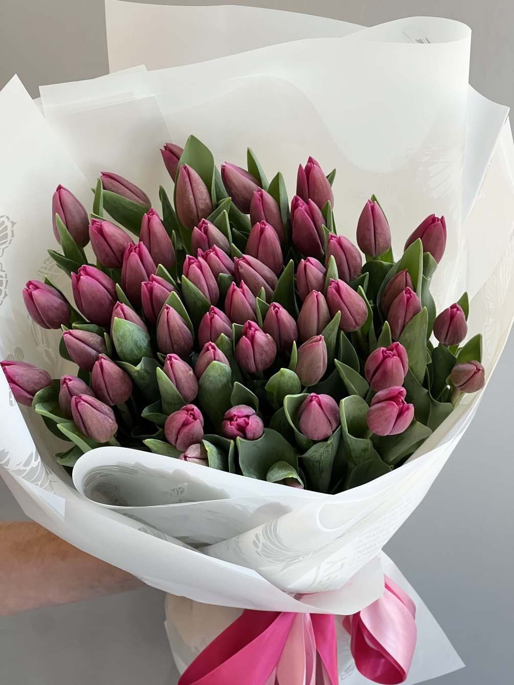 50 Tulips hand tide bouquet in a wrapping paper with the satin