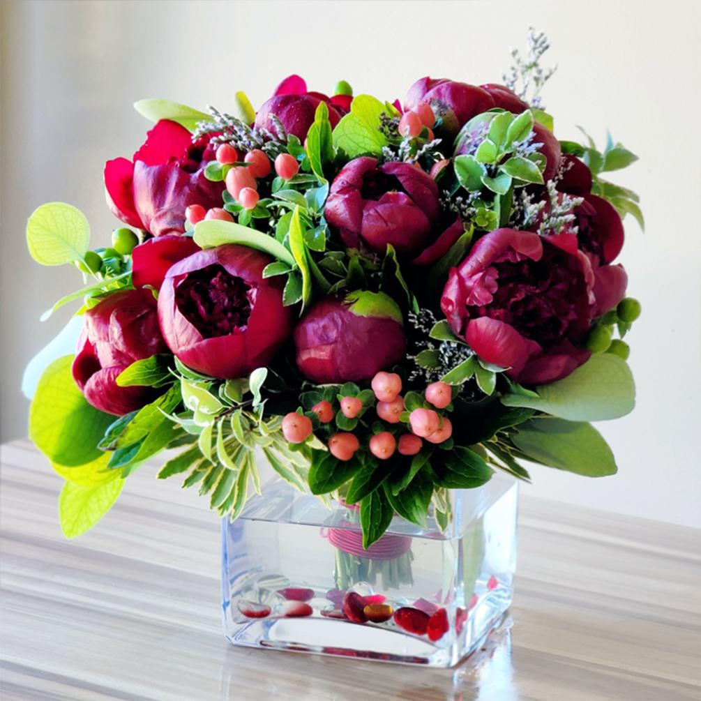 Peony Red Charm Bouquet crafted with seasonal accents. 
Approximately 11&quot; H x
