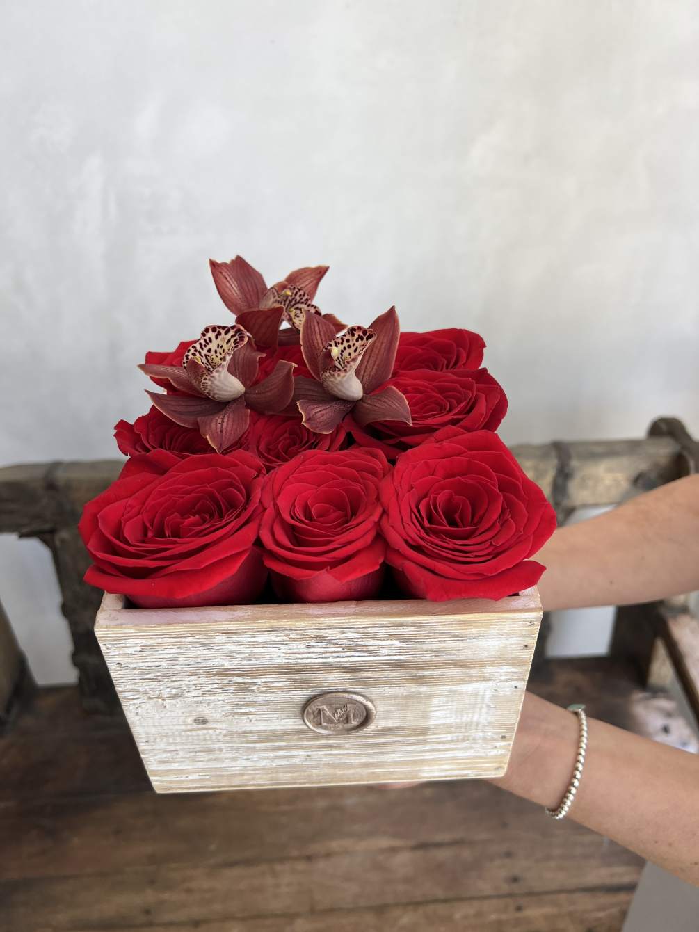 This luxurious arrangement showcases the timeless allure of red roses and the