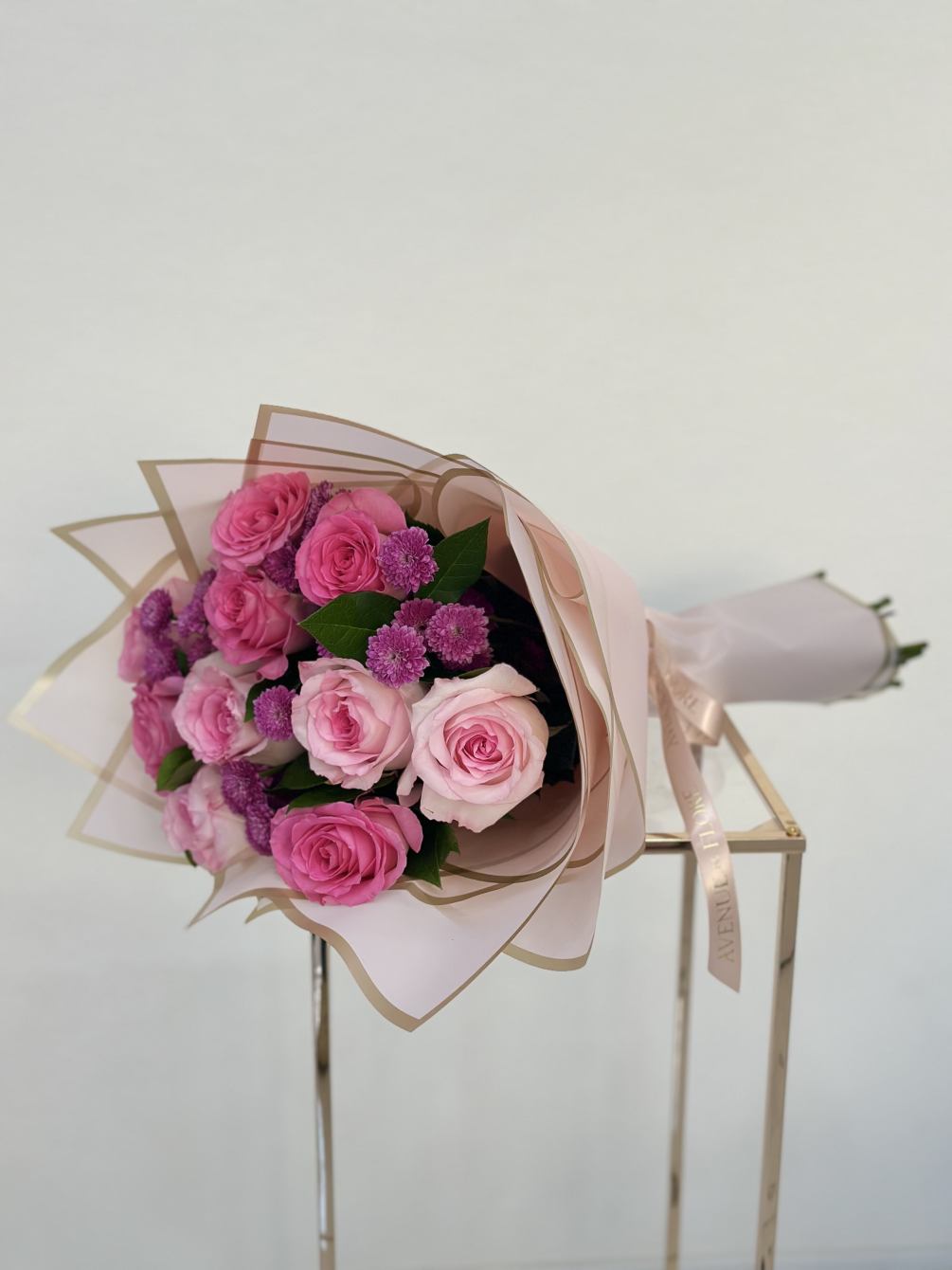 This charming bouquet blends the playful elegance of pink roses with the