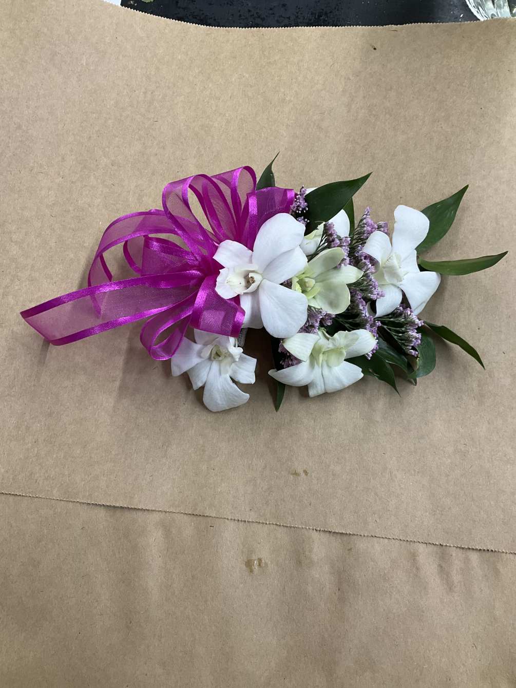 A beautiful orchid corsage perfect for your next prom, graduation or even