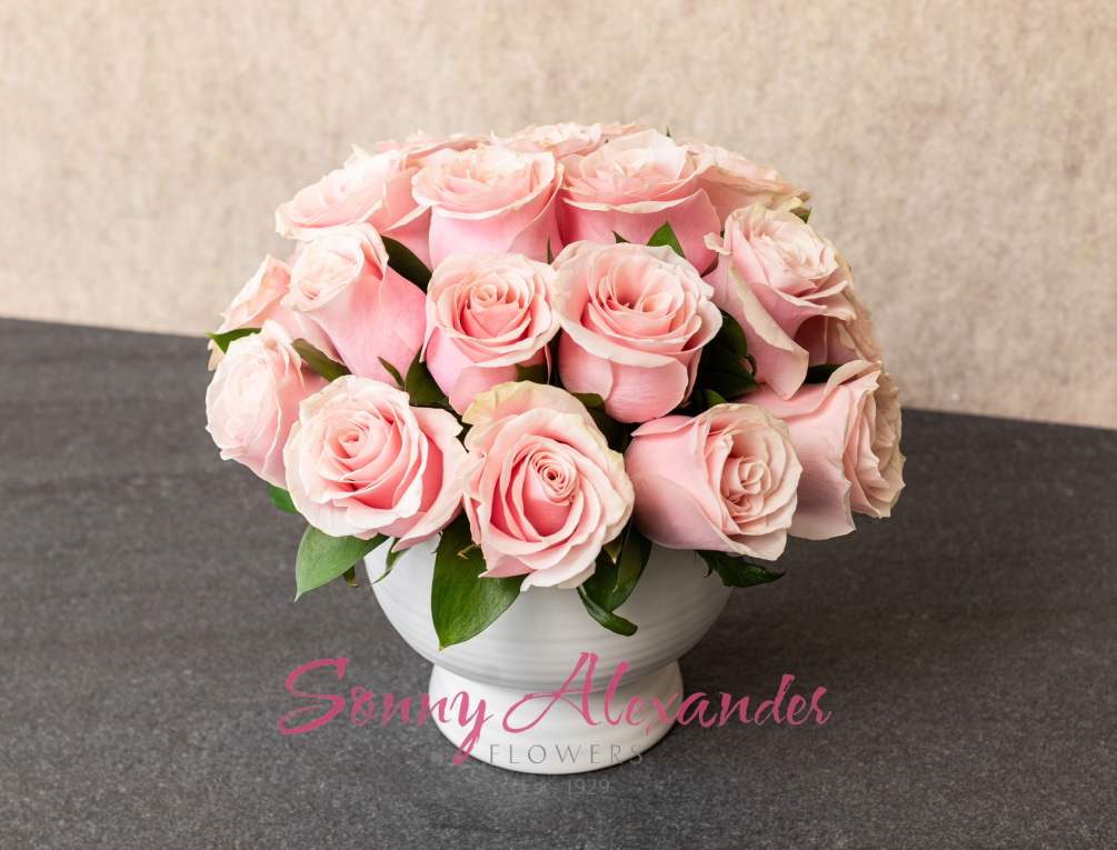 &quot;Pink Petal Serenity&quot; is a graceful floral arrangement featuring twenty-five pink roses