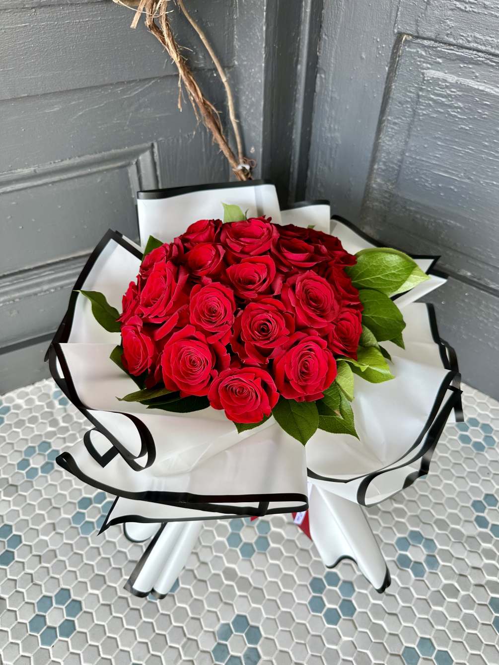 A stunning hand-tied bouquet of red roses, perfect to show that special