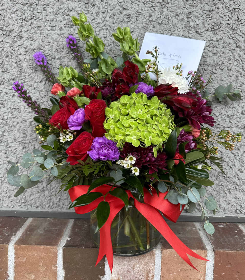 Vibrant floral arrangement in a clear glass vase. The bouquet features a