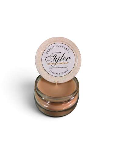 Small scented candle in a glass jar with a round lid label