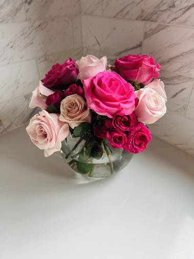 Bouquet of pink and white roses in a clear glass vase