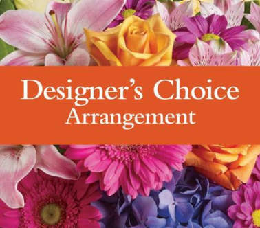 Colorful mixed flowers behind an orange banner reading Designer's Choice Arrangement