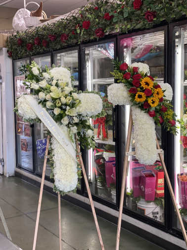 Two large floral standing sprays on easels with white and red flowers