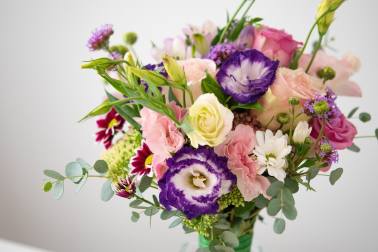 Bouquet of pink, purple, and white flowers with greenery