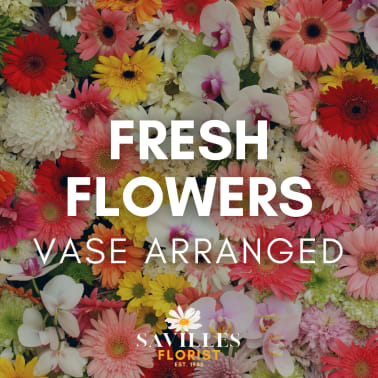 Colorful mixed flower arrangement with gerbera daisies and orchids
