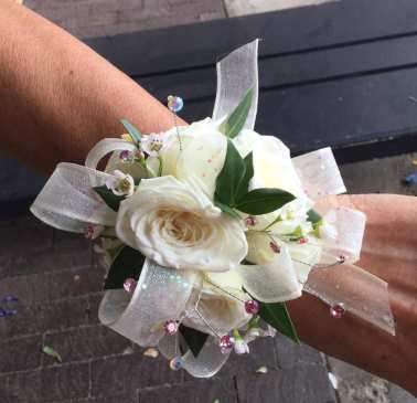 White rose wrist corsage with sheer ribbon and pink crystal accents
