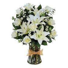 White lilies and roses in a glass vase