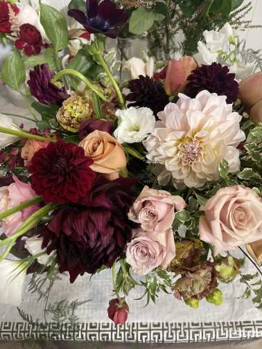 Mixed bouquet of roses, dahlias, and white blooms in pink, burgundy, and cream