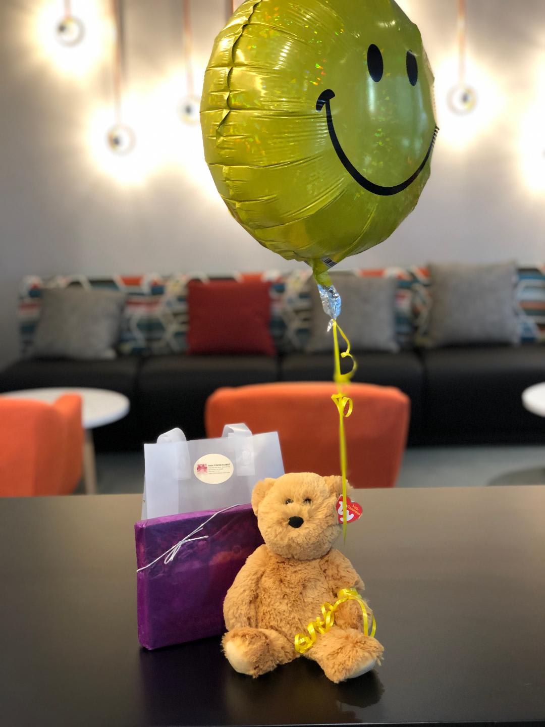 teddy bear with blue balloons