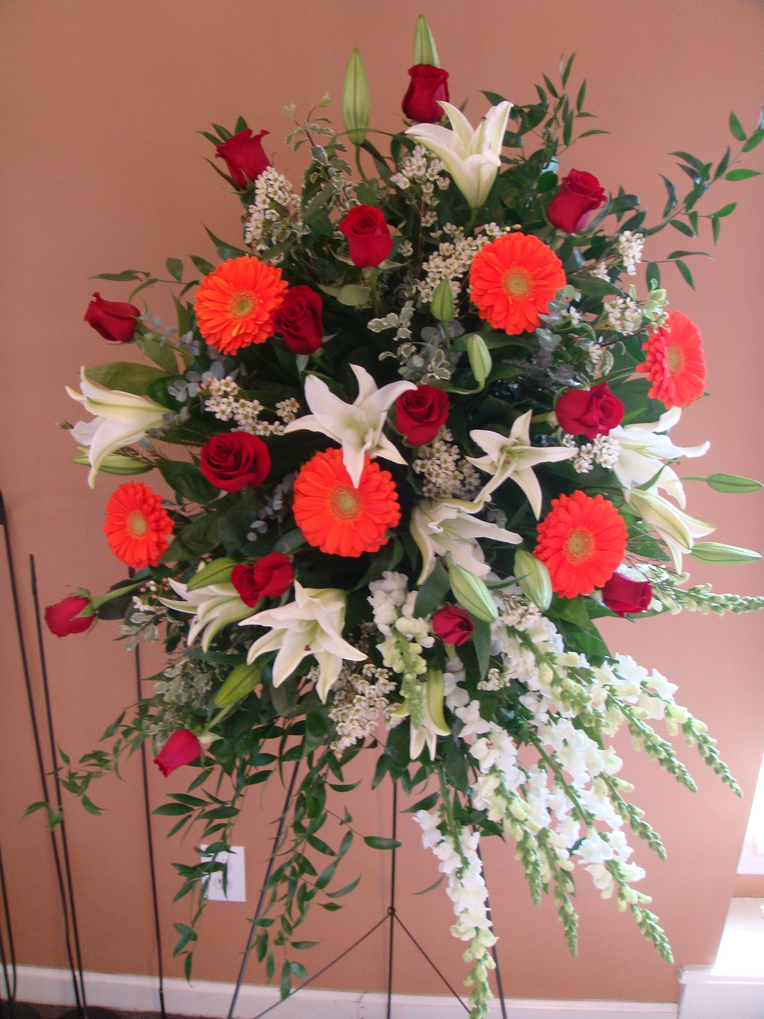 Sympathy Spray Of Roses, Gerber Daisies,Snap Dragons & Wax Flowers in