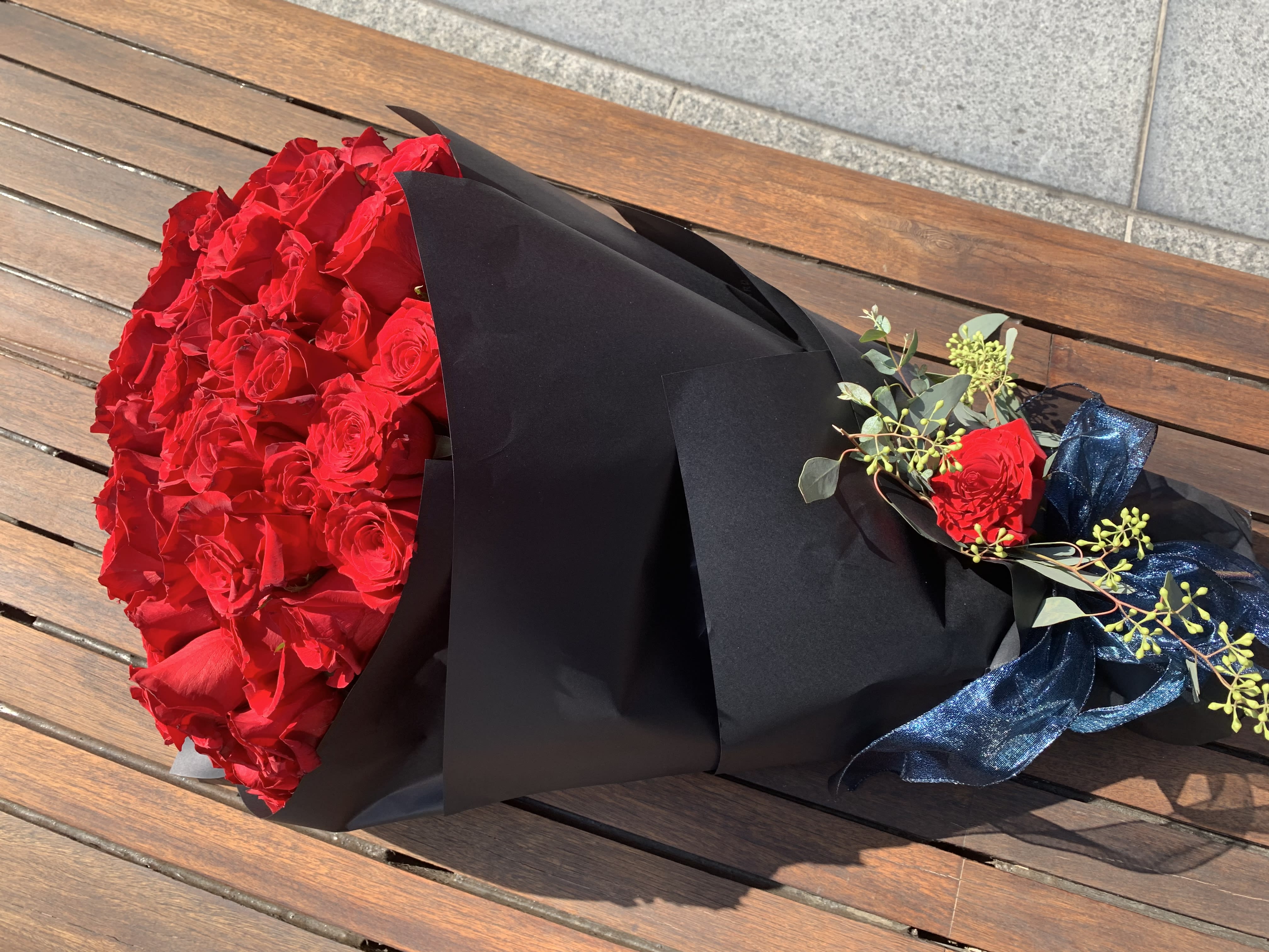 100 Red Roses Wpapped on Black Paper Bouquet