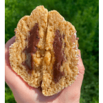 Hand holding a split chocolate-filled cookie