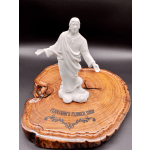 White religious figurine on a wooden display base