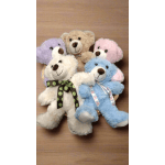 Five plush teddy bears in pastel colors arranged in a basket