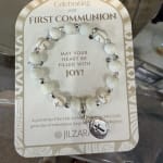 Beaded First Communion bracelet on a printed card