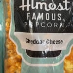 Bag of cheddar cheese popcorn with a black and teal label