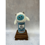 Plush yeti toy sitting in a labeled can on a wooden stand