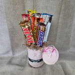 Candy bars arranged in a pink Hydro Flask mug with a matching lid