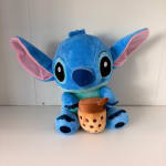 Blue plush Stitch holding a bubble tea cup